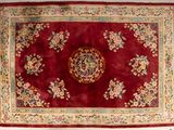 an image of a red rug with a floral design on it