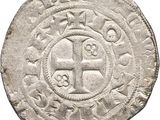 an old silver coin with a cross on it