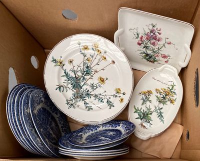 many plates and bowls in a cardboard box