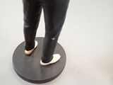 a statue of a man standing on top of a table
