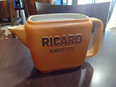 une tasse posée sur une table, sur laquelle figure un nom