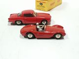 two toy cars sitting next to each other on a table