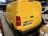 a yellow van that is parked in a parking lot