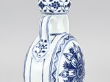 a blue and white vase with a flower design on it