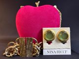 two pairs of earrings and a pink heart on a black background
