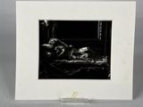 black and white photograph of a woman laying on a bed in a room