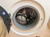 a close up of a washing machine with the door open