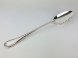 a close up of a spoon on a table with a white background