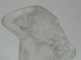 statue of a woman with her hands on her head