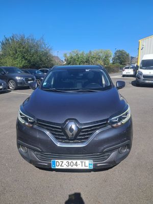 the front view of a black car parked in a parking lot