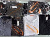 a lot of shirts that are sitting on a table