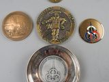 a silver plate with coins and a clock on it