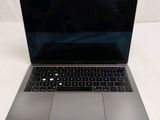 a close up of a laptop computer on a white surface