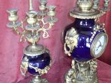 two blue and gold vases on a red cloth