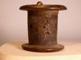 a brown vase sitting on top of a wooden table