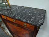 a marble top on a wooden dresser in a room