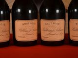 four bottles of brut rose wine lined up on a table