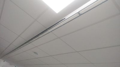 a bathroom with a toilet and a sink under a skylight