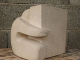 a white sculpture sitting on top of a wooden table