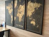 three framed maps on the wall of a home office