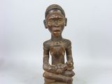 a wooden statue of a woman holding a baby in her arms