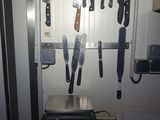 many knives hanging on the wall next to a toaster oven