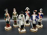 six figurines of soldiers in different colors and sizes