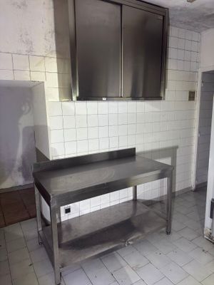 a kitchen with stainless steel counter tops and cabinets