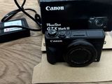 a black camera sitting on top of a cardboard box on a table