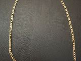 a gold chain with a tag attached to it