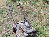 a lawn mower that is sitting in the grass