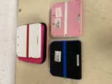 several different colored electronic devices are lined up on a wall