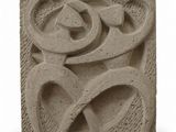 a close up of a stone block with a design on it