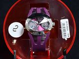 a purple watch in a red case on a black surface