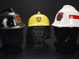 three different types of hard hats on display against a black background