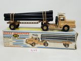 a toy truck with a large pipe on the back of it