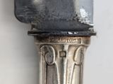 a close up of a silver spoon on a table