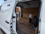 a white van with its door open on the street