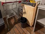 a shopping cart sitting next to a computer on a desk
