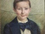 portrait of a young boy in a blue suit and bow tie