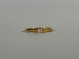 a close up of a gold ring with a diamond on it