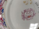 a small cup and saucer with a label on it