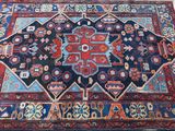 rug on the floor is blue and red with a design on it