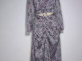 the dress is purple and white with black spots on it