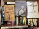 many books that are sitting in a box on the shelf