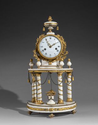 une horloge blanche et or posée sur une table