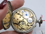 a close up of a person holding a pocket watch