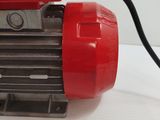 a red and yellow motor with a black wire attached to it