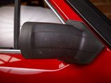 an image of a red car with a cat in the window