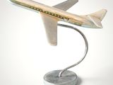 a model of a plane on a stand on a white surface
